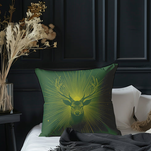 A pillow cover with a majestic stag illustrated in metallic gold on deep moss green fabric. Gleaming rays extend outward from the deer's head, with small golden stars dispersed throughout.